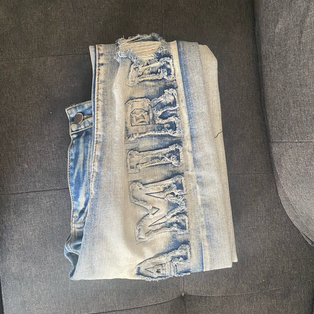 AMIRI Light Blue Distressed Denim with Bold Lettering